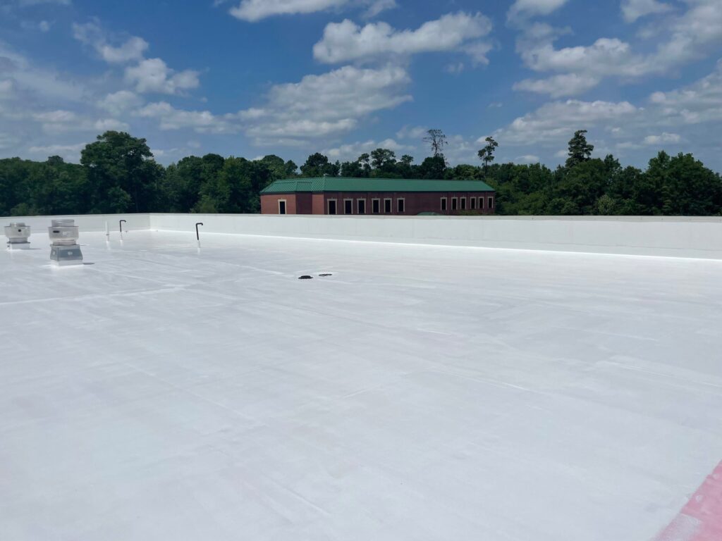 Finished commercial flat roof coating in Houston TX with white reflective energy-efficient roof system
