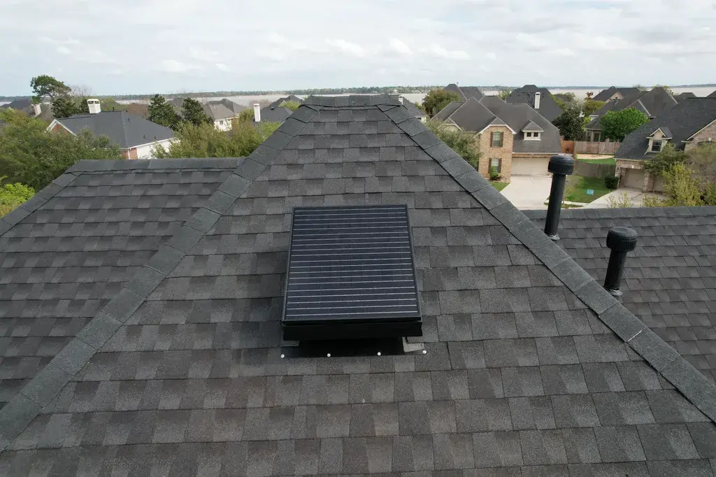 Gray shingle roof with new vent after repairs by STX Roofing in Houston TX